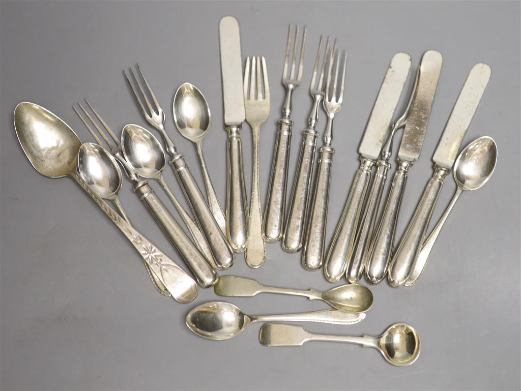 A set of six silver handled dessert forks, four silver handled dessert knives, a Georgian silver dessert fork, five silver teaspoons et